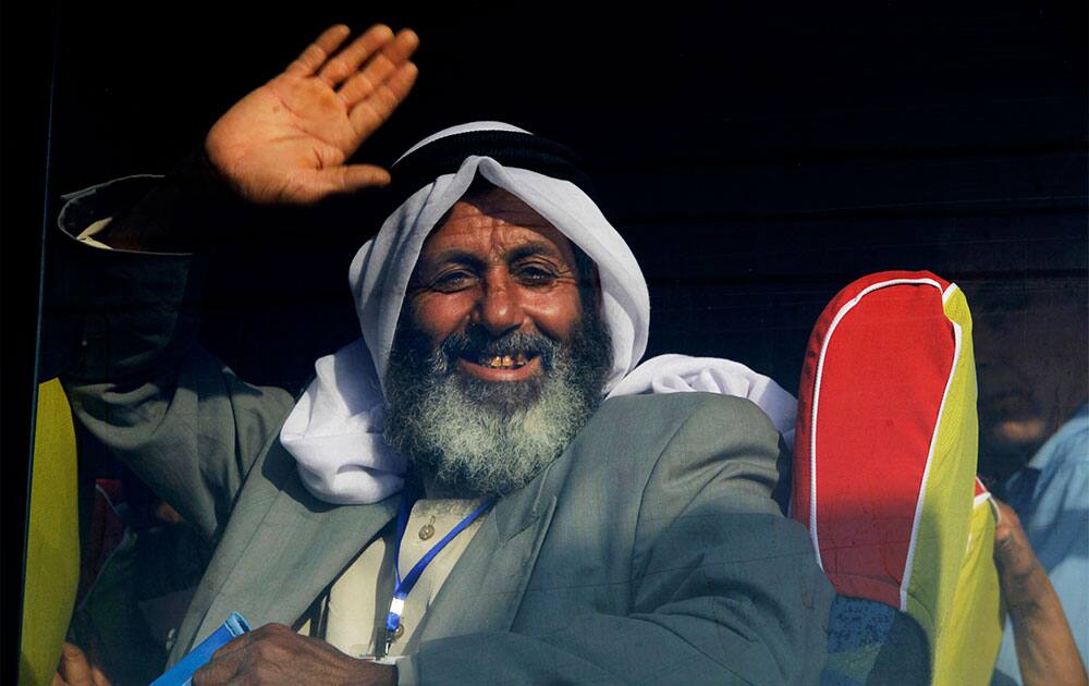 A Palestinian Muslim pilgrim waves to his relatives from a bus en route to Rafah border between Gaza Strip and Egypt before leaving for the annual hajj pilgrimage to the holy city of Mecca, in Gaza City.