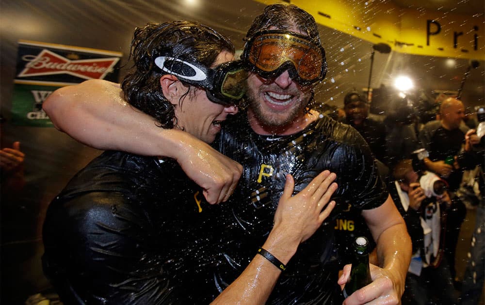 Pittsburgh Pirates pitchers Jason Grilli, right, and Jeff Locke celebrate after beating the Cincinnati Reds in the National League Wild-Card playoff baseball game, 6-2, in Pittsburgh.