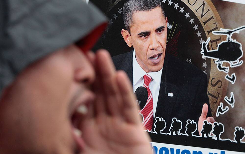 A Filipino protester shouts slogans in front of a picture of US President Barack Obama during a rally outside the Camp Aguinaldo military headquarters in suburban Quezon city, north of Manila.