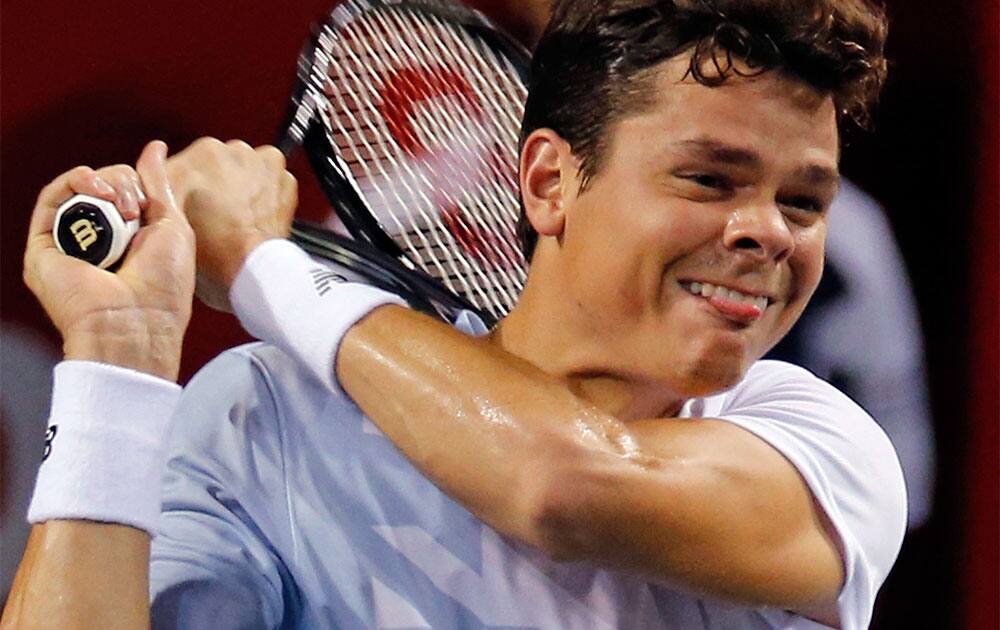 Milos Raonic of Canada returns a shot against Go Soeda of Japan during their match at the Japan Open Tennis Championships in Tokyo.