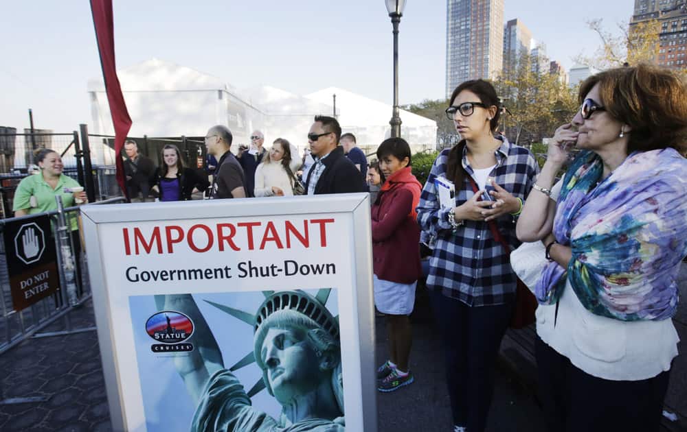Tourists who had hoped to visit the Statue of Liberty stand near the dock used by Liberty Island ferries in New York. A government shutdown, the first since the winter of 1995-96, closed national parks across the nation.