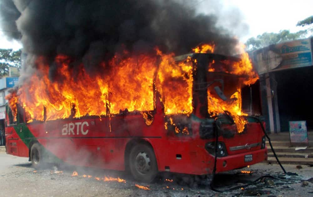 A bus stands in flames after it was set on fire by activists of the opposition Bangladesh Nationalist Party (BNP) to protest against the death sentence awarded to their leader Salauddin Quader Chowdhury in Chittagong, Bangladesh.