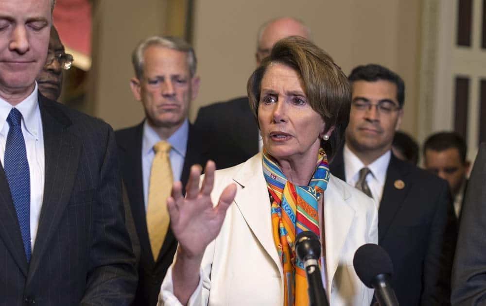 House Minority Leader Nancy Pelosi, D-Calif., center, and House Democratic leaders speak to reporters just before midnight at the Capitol in Washington.
