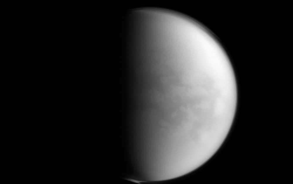 This undated image provided by NASA shows Saturn’s largest moon, Titan. NASA’s Cassini spacecraft has detected the presence of a plastic ingredient in Titan’s atmosphere, the first time the chemical has been found in a world other than Earth.