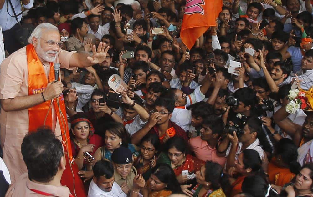 Bharatiya Janata party leader Narendra Modi waves to supporters as he arrives to address a public rally in Mumbai.