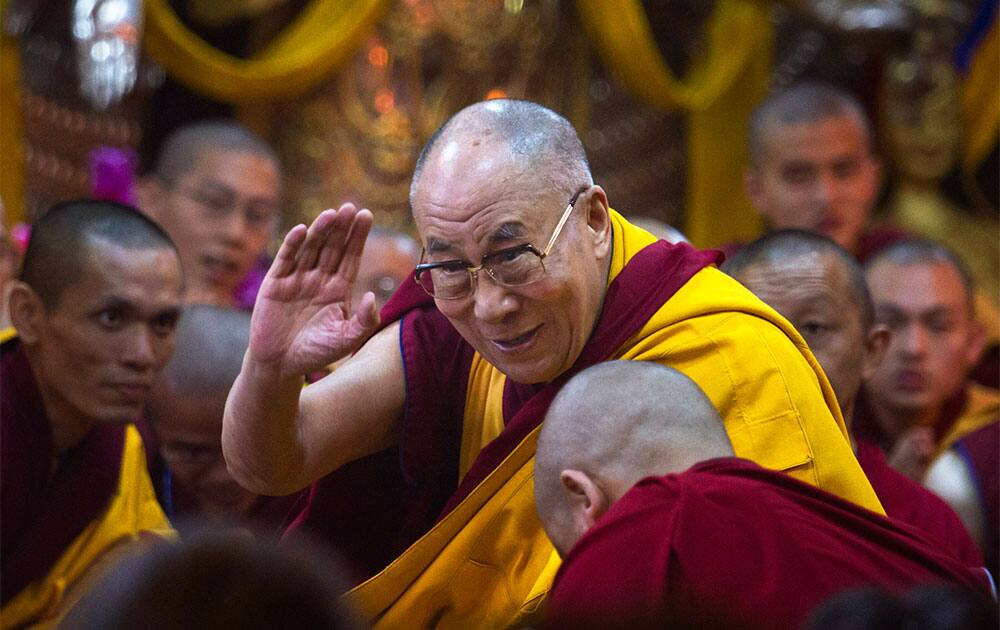 Tibetan spiritual leader, the Dalai Lama, greets devotees at the Tsuglakhang temple after he arrived to give a religious talk, in Dharmsala.