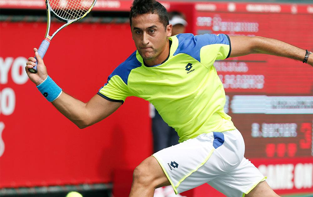 Nicolas Almagro of Spain returns a shot to Benjamin Becker of Germany during their first round match of the Japan Open Tennis Championships.