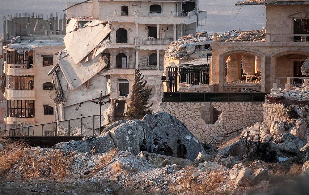 Syrian opposition fighters take cover during exchange of fire with government forces in Telata village, a frontline located at the top of a mountain in the Idlib, northwest province countryside of Syria.