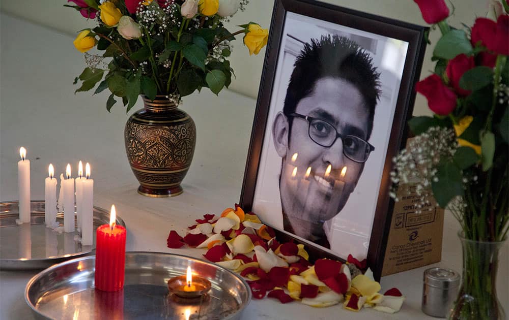 Candles reflect on the photo of late 24-year old Rajan Lalitkumar Solanki, during a prayers ceremony at Arya Samaj Temple in Nairobi, Kenya.
