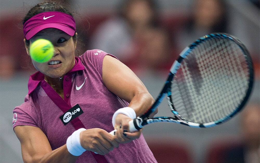Li Na of China returns a backhand shot to Daniela Hantuchova of Russia during their first round of the China Open tennis tournament at the National Tennis Stadium in Beijing, China.