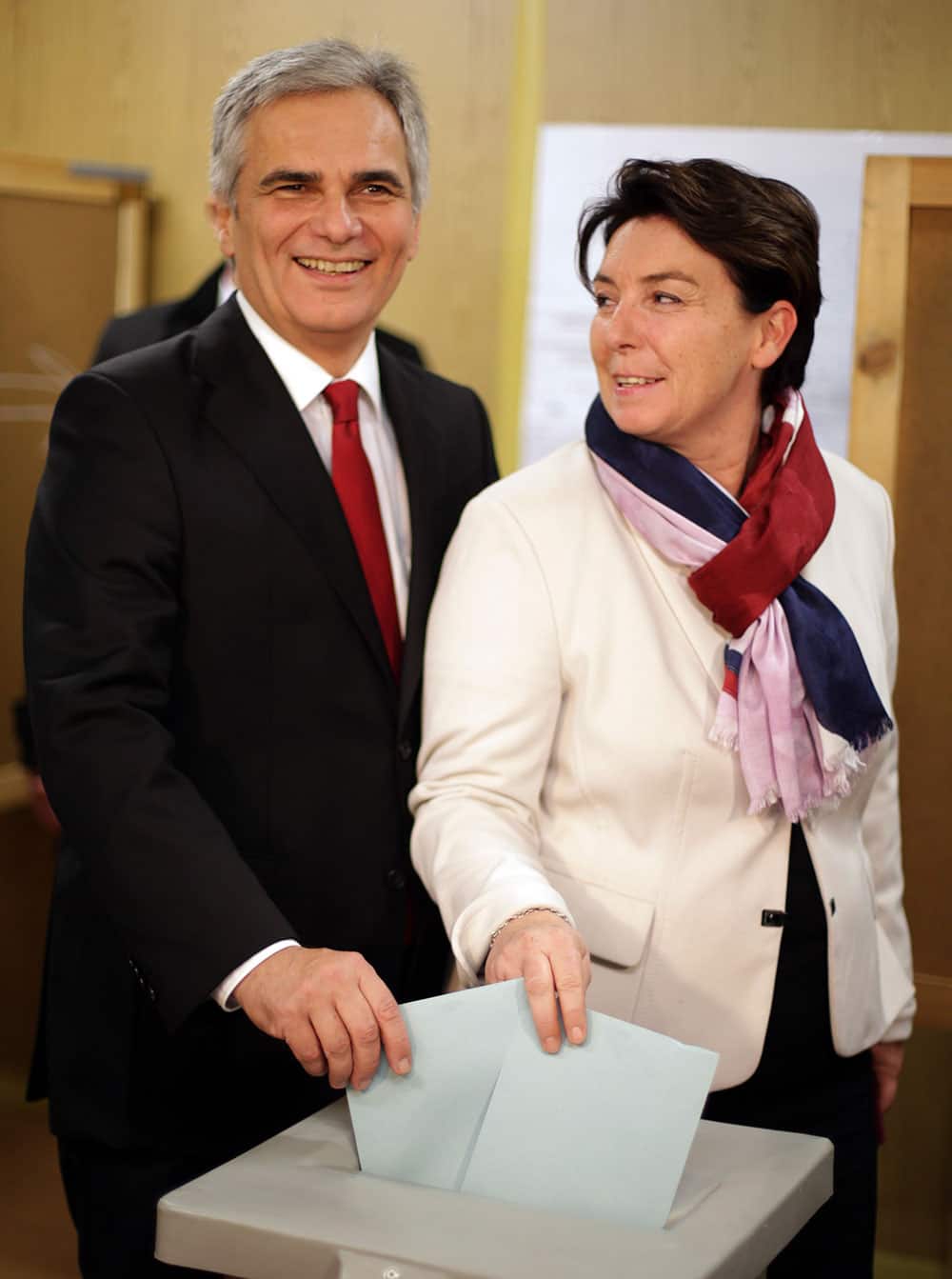 Top candidate of the Social Democrats, SPOE, Werner Faymann, left, and his wife Martina Ludwig-Faymann cast their votes in national elections at a polling station in Vienna, Austria. Austrians went to the polls to elect a new parliament.