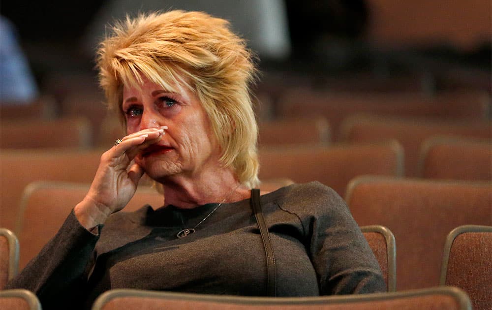 A tearful Shari Turbyfill, step mom to Travis Turbyfill who died fighting the Yarnell wildfire, listens to a panel announce their findings as the official report is released Saturday, Sept. 28, 2013, examining to explain how 19 members of an elite firefighting crew died while battling the Arizona wildfire, in Prescott, Ariz.