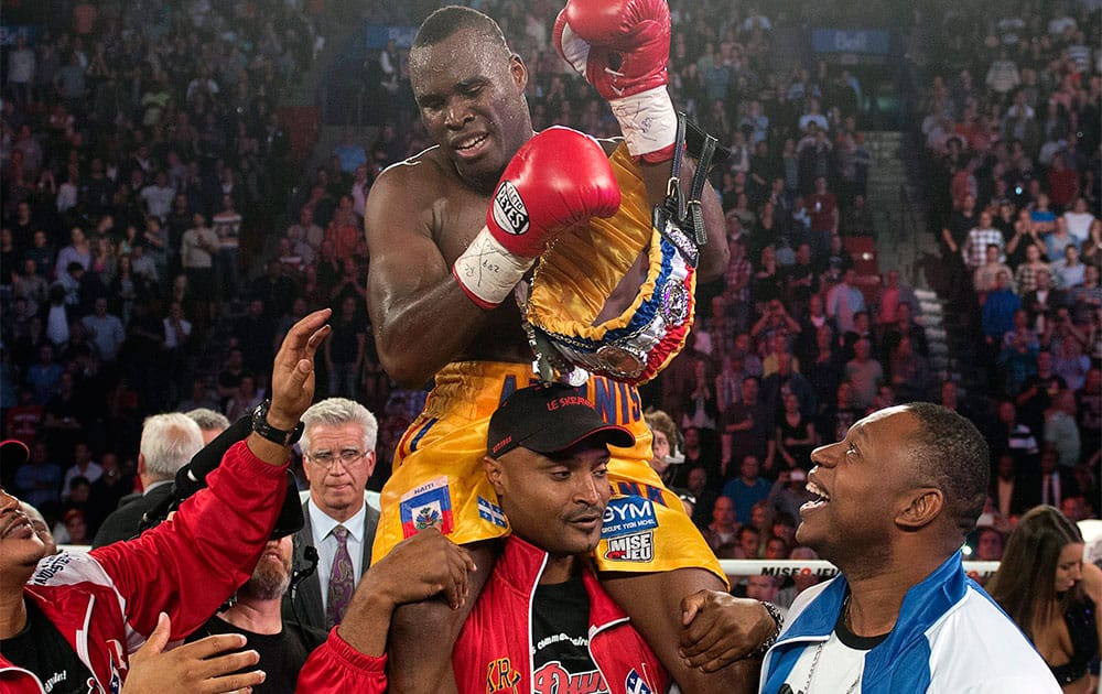 Adonis Stevenson, from Montreal, celebrates after defeating Tavoris Cloud to defend his light heavyweight title in a boxing bout Saturday, Sept. 28, 2013, in Montreal.