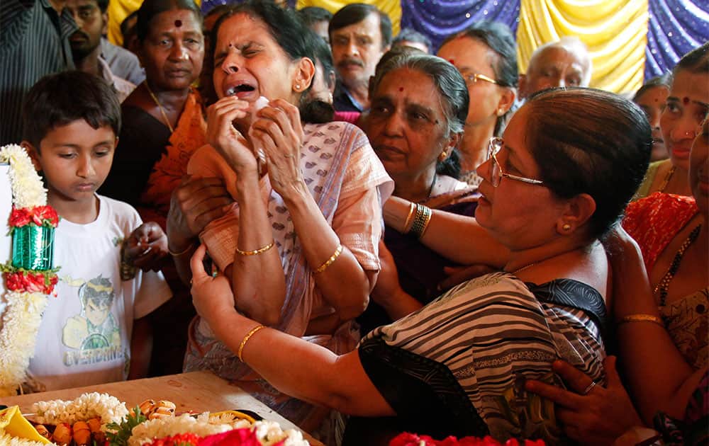 Nagamani, center, wails next to the coffin of her brother Sudharshan B. Nagaraj, who died in an attack on Westgate Mall in Nairobi, Kenya, during his funeral in Hejjala, 30 Kilometers (19 miles) from Bangalore.