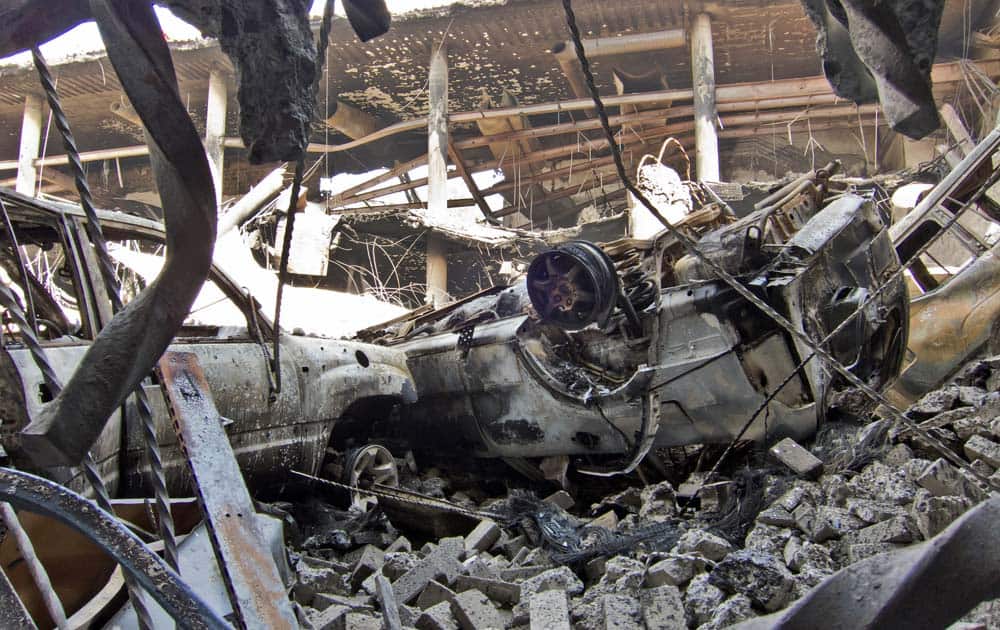 Vehicles that plunged down during the collapse of the upper car park level lie amidst the rubble below, viewed from the basement car park, at the Westgate Mall in Nairobi, Kenya.