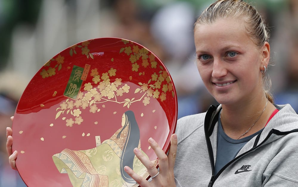 Petra Kvitova of the Czech Republic holds her winner`s plate for photos during an award ceremony following her victory over Angelique Kerber of Germany at the final match of the Pan Pacific Open Tennis tournament in Tokyo.