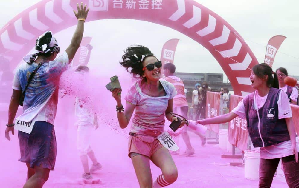 Runners get pelted with different color powders upon their crossing the finish line during the Color Run at the Dajia Riverside Park in Taipei, Taiwan.
