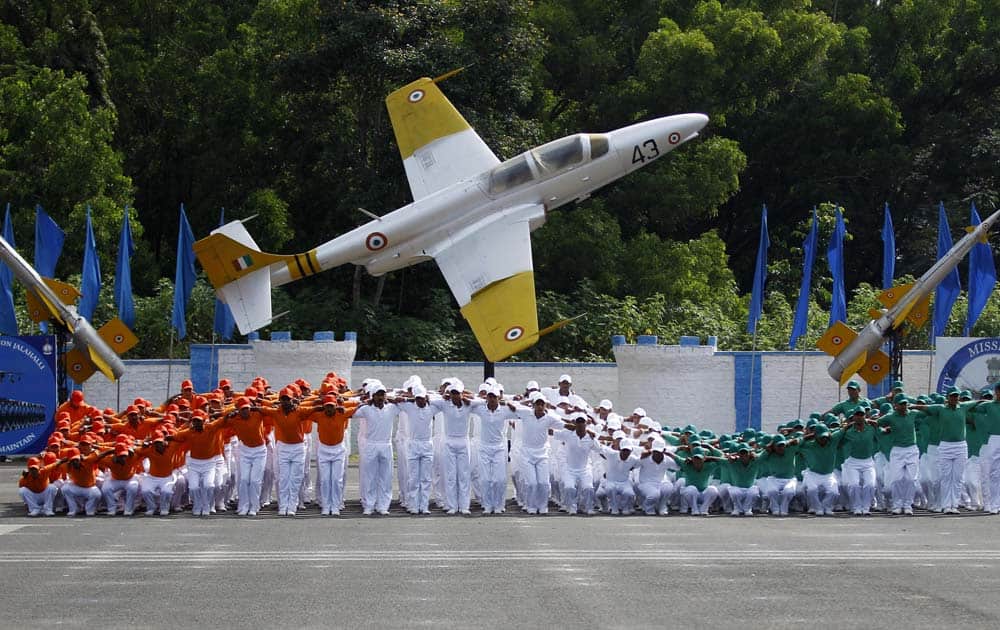 Indian Air Force trainees dressed in the Indian tri-colored flag perform during the passing out parade ceremony of their seniors in Bangalore.
