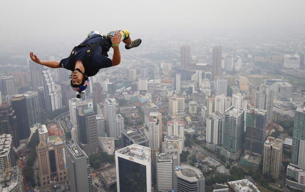 Base jumper Vincent Philippe Benjamin Reffet of France leaps from the 300-meter Open Deck of the Malaysia`s landmark, Kuala Lumpur Tower during the International Tower Jump.