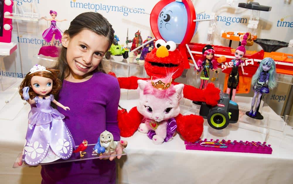 Madysin Shipman shows off the toys named to the TimetoPlayMag.com 2013 Most Wanted list, a roundup of 20 items predicted to be the most in-demand this holiday season, during the TimetoPlayMag.com Holiday Showcase press event, in New York.