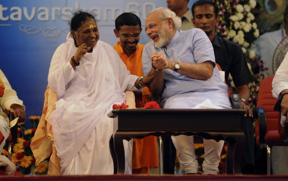 Gujarat Chief Minister Narendra Modi shares a lighter moment with spiritual leader Mata Amritanandamayi during her 60th birthday celebrations at Vallikavu, near Kollam, Kerala.
