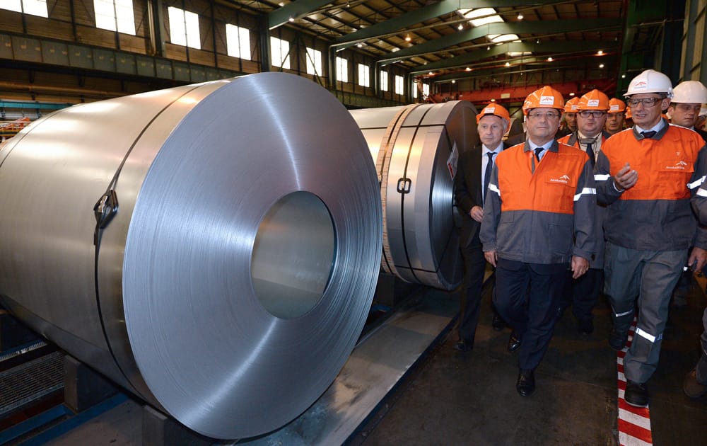 French President Francois Hollande visits with unidentified Arcelor Mittal executives, the steel factory Arcelor-Mittal in Florange, eastern France.