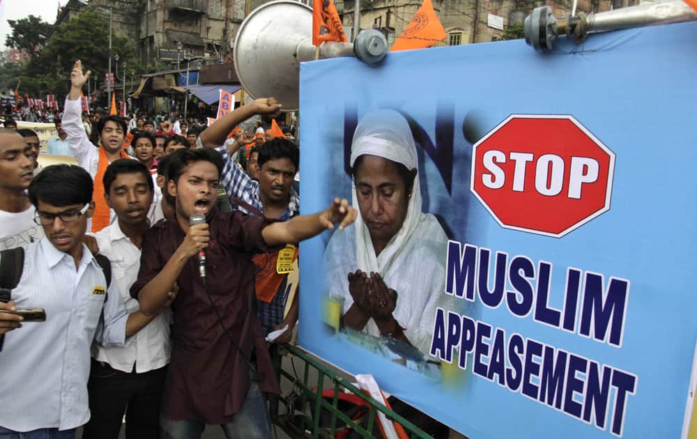 Students shout slogans beside a photograph of West Bengal Chief Minister Mamata Banerjee during a protest by Akhil Bharatiya Vidyarthi Parishad (ABVP) in Kolkata.
