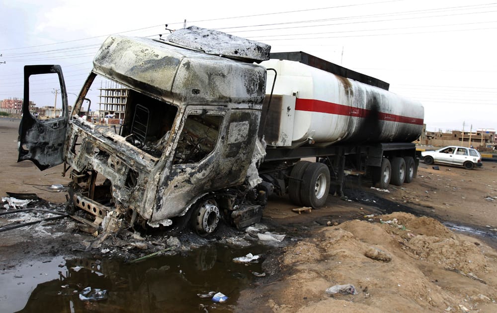 A destroyed fuel tanker is left behind after rioters torched a fuel station in Khartoum, Sudan.