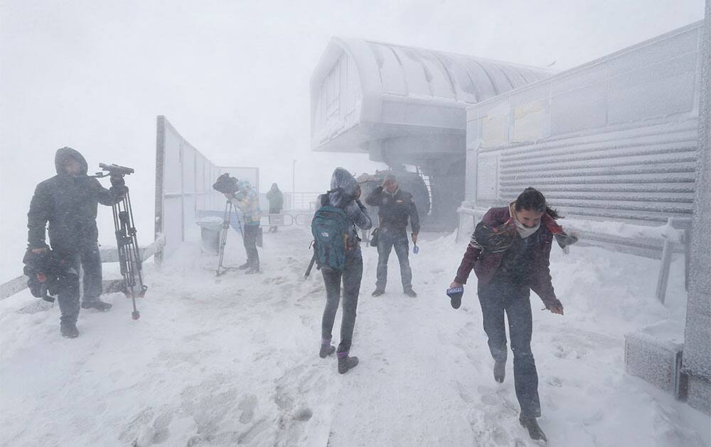 Journalists working during a heavy snowfall on a highest point of