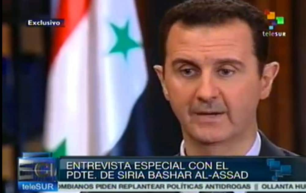 Syria`s President Bashar Assad speaks during an interview with a Telesur reporter in Damascus, Syria. Telesur is a Latin American news channel financed primarily by Venezuela`s government.