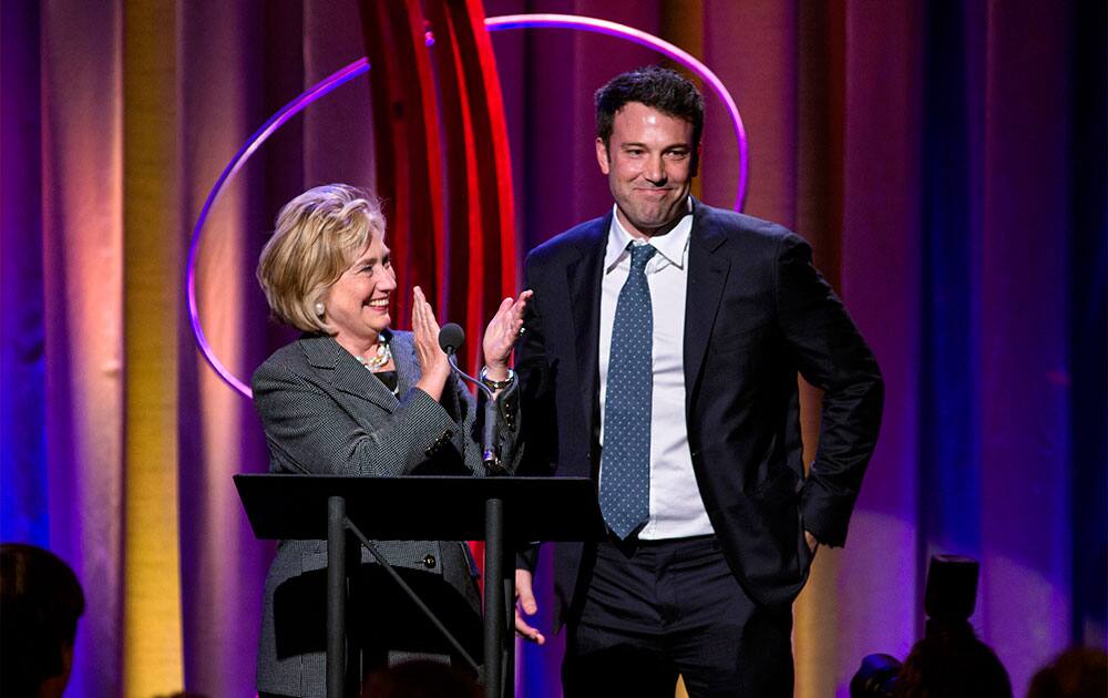 Former Secretary of State Hillary Rodham Clinton applauds actor Ben Affleck, right, during the Clinton Global Initiative`s annual awards in New York. Clinton and Joe Biden appeared together during the event.
