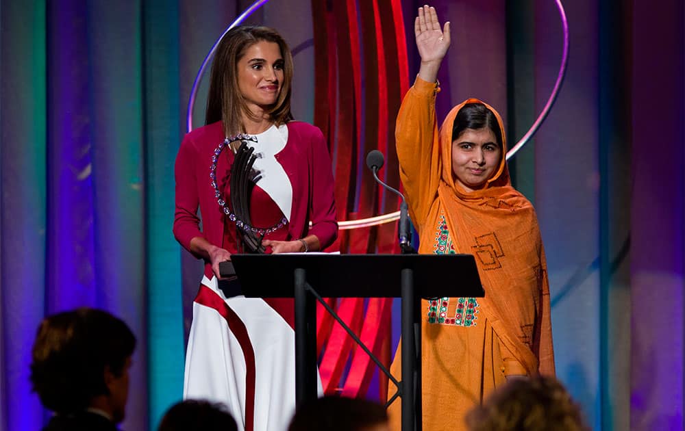 After speaking to attendees, Malala Yousafzai, the Pakistani teenager shot by the Taliban for promoting education for girls, waves to the crowd after receiving the Leadership in Civil Society Award from Queen Rania of Jordan, left, at the Clinton Global Initiative`s Citizen Awards Dinner in New York.