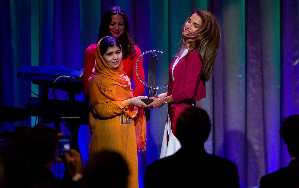Malala Yousafzai, the Pakistani teenager shot by the Taliban for promoting education for girls, is given Leadership in Civil Society award by Queen Rania of Jordan at the Clinton Global Initiative`s Citizen Awards Dinner in New York.