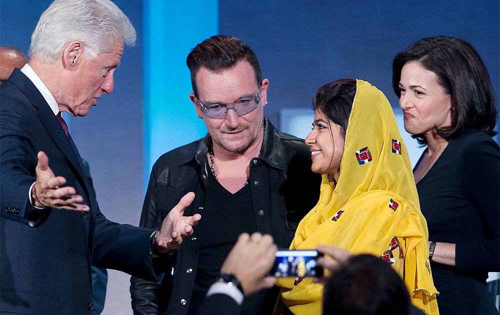 Former President Bill Clinton, left, talks with Bono, Khalida Brohi, founder of the Sughar Empowerment Society, and Sheryl Sandberg, the chief operating officer of Facebook, at the Clinton Global Initiative, in New York. Clinton moderated their panel discussion on
