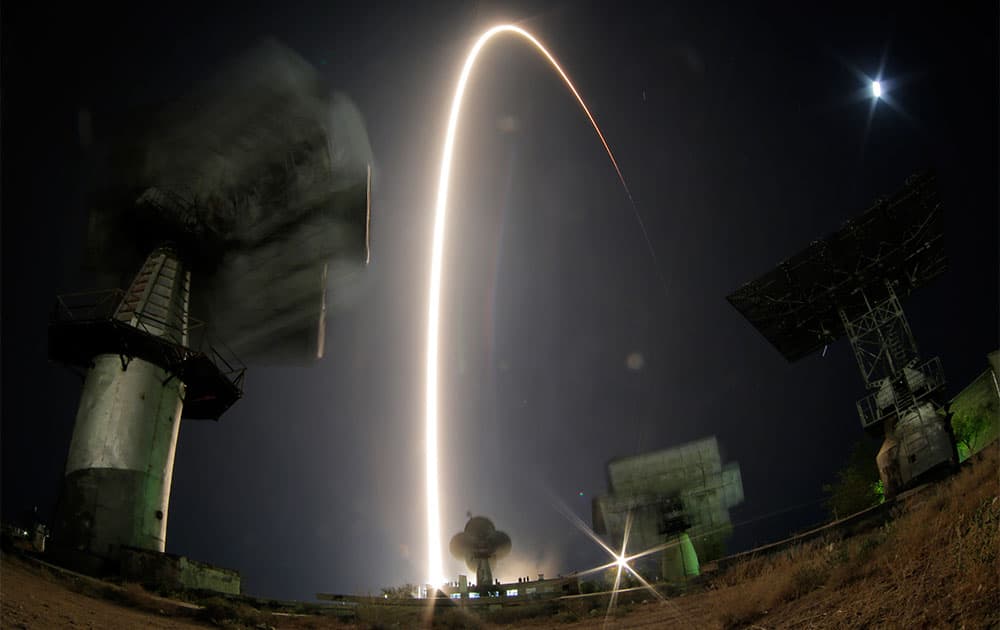 In this photo taken with a fisheye lens and with long time exposure the Soyuz-FG rocket booster with Soyuz TMA-10M space ship carrying a new crew to the International Space Station, ISS, blasts off at the Russian leased Baikonur cosmodrome, Kazakhstan.