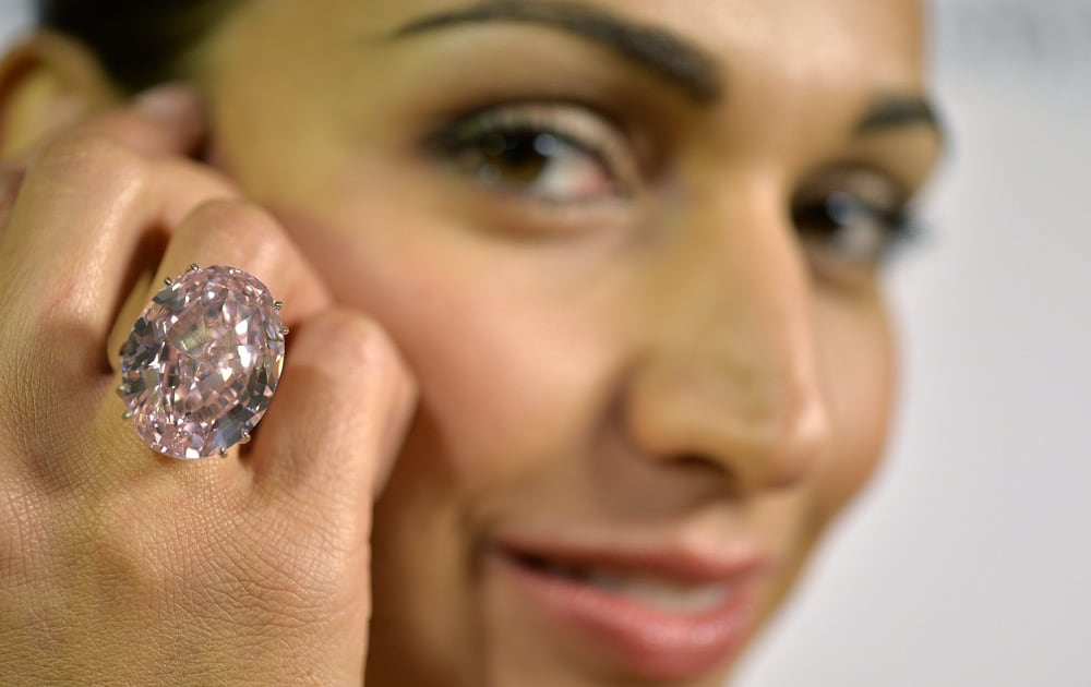 A Sotheby`s employee shows The Pink Star diamond weighing 59.6 carat, during a preview at Sotheby`s, in Geneva, Switzerland.