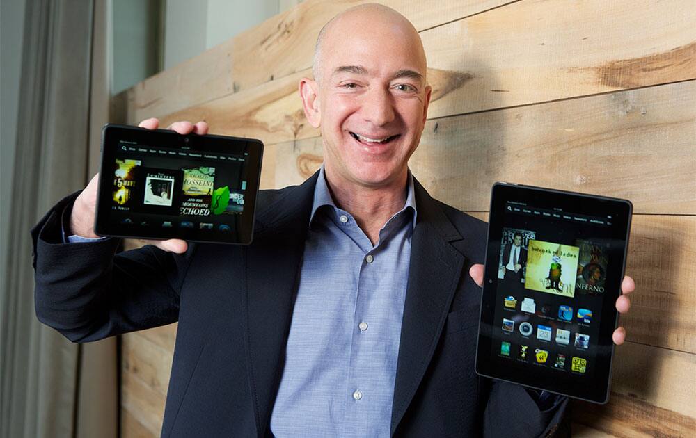 Amazon.com Founder and CEO Jeff Bezos introduces the all-new Kindle Fire HDX 8.9``, right, and Kindle Fire HDX 7`` tablet in Seattle.