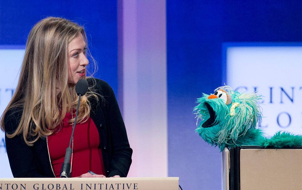 Chelsea Clinton reacts to Rosita, a character from Sesame Street, at the Clinton Global Initiative, in New York. Clinton moderated a panel on