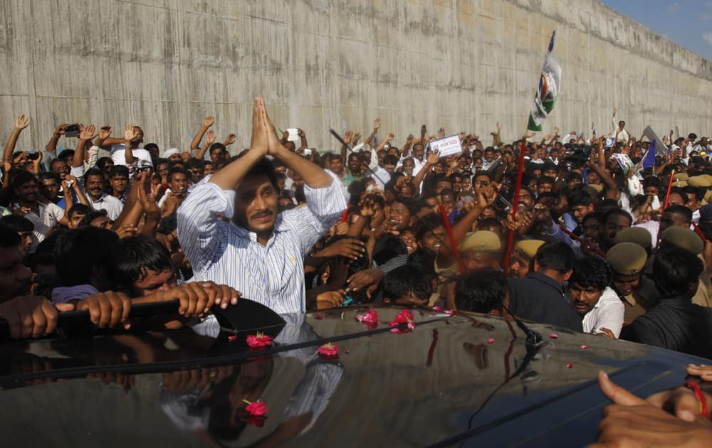 YSR Congress party chief Jagan Mohan Reddy greets supporters after he was released on bail from the Chanchalguda Central Prison in Hyderabad.