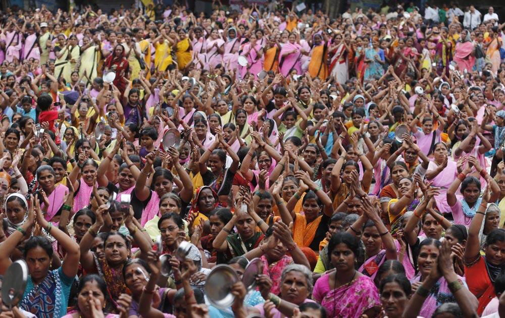 Workers of Anganwadi, or government-sponsored child-care and mother-care, beat plates with spoons and clap their hands during a protest in Mumbai.