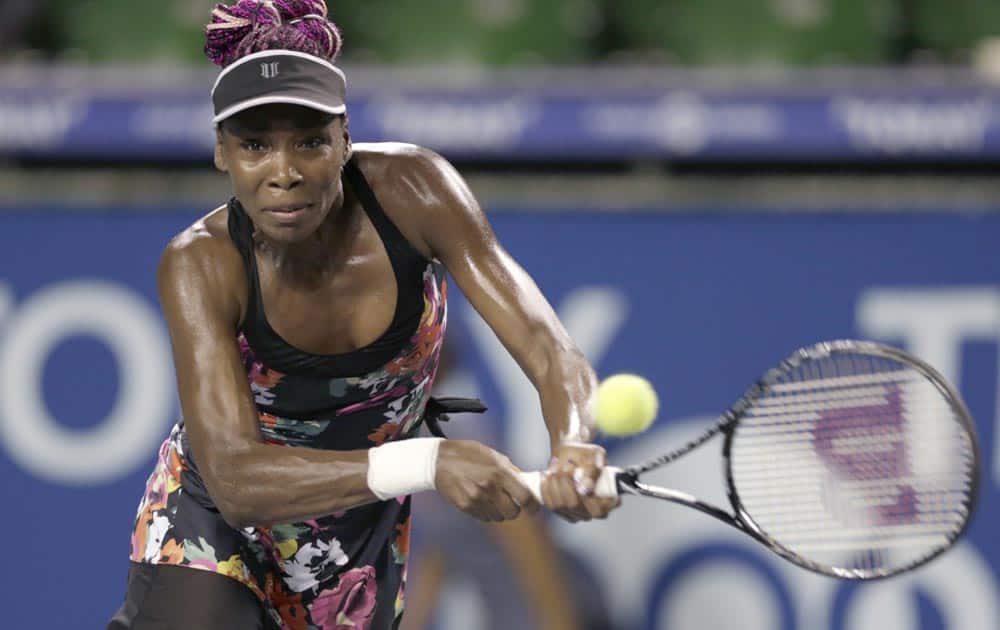Venus Williams of the United States returns the ball against Victoria Azarenka of Belarus during their second round match of the Pan Pacific Open tennis tournament in Tokyo.