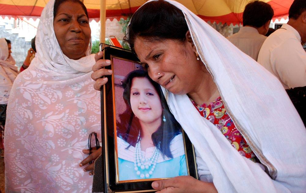 A Pakistani Christian mother holds a picture of her daughter, who lost her life in a suicide bombing of the All Saints Church in the northwestern city of Peshawar, Pakistan.