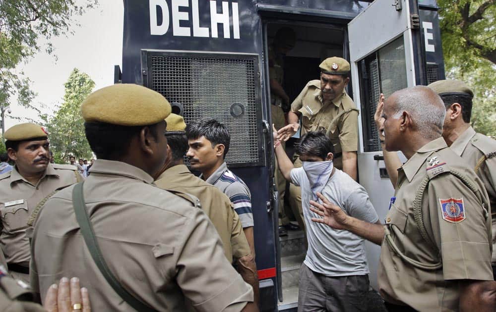 Akshay Thakur and Pawan Gupta, two of the four men sentenced to death for raping and torturing a young woman on a moving bus, get down from a police van as they are brought to High Court in New Delhi.