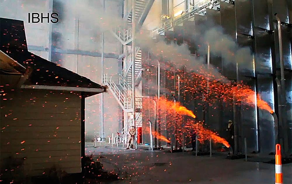 This frame grab from video shows embers being shot at a structure during a test at the Insurance Institute for Business and Home Safety test facility in Richburg, S.C.