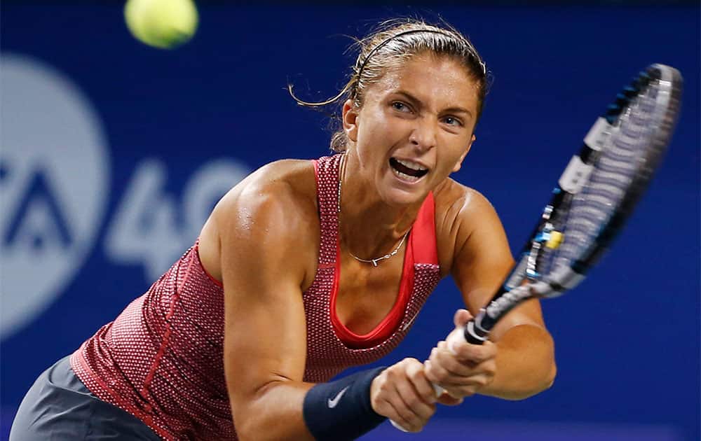 Sara Errani of Italy returns a shot against Svetlana Kuznetsova of Russia during their second round match of Pan Pacific Open Tennis tournament in Tokyo.