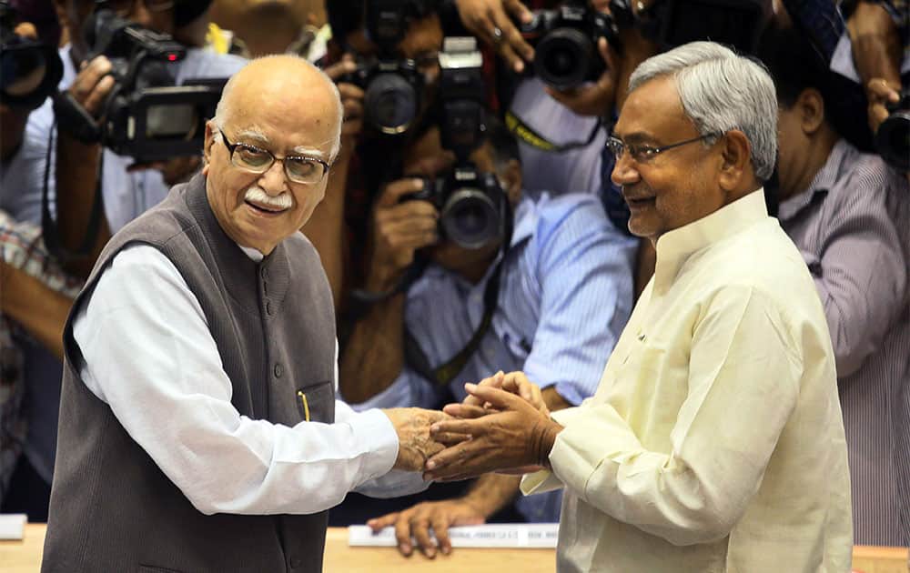 India`s main opposition Bharatiya Janata Party (BJP) leader L.K. Advani, left, greets Bihar State Chief Minister Nitish Kumar as they arrive to attend the 16th National Integration Council meeting, in New Delhi.