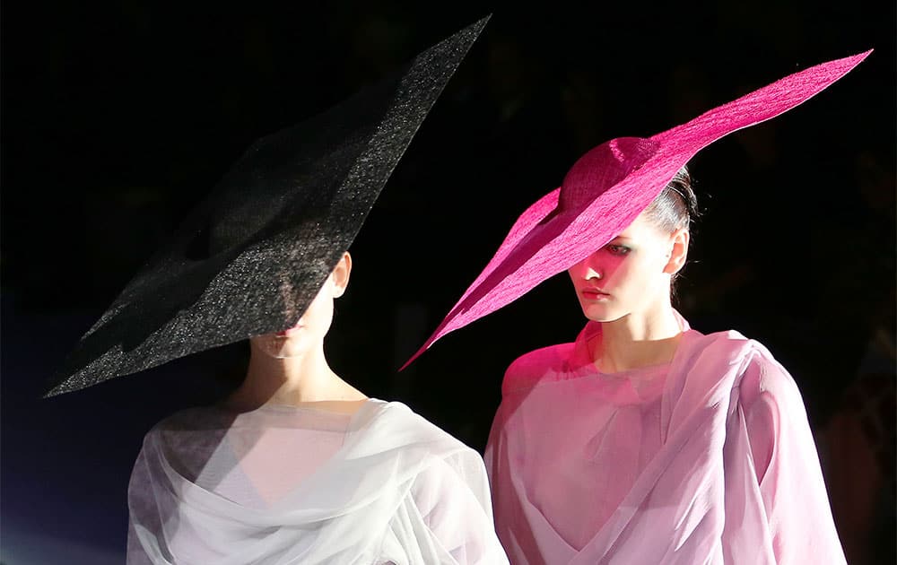 Models wear creations for Giorgio Armani women`s Spring-Summer 2014 collection, part of the Milan Fashion Week.