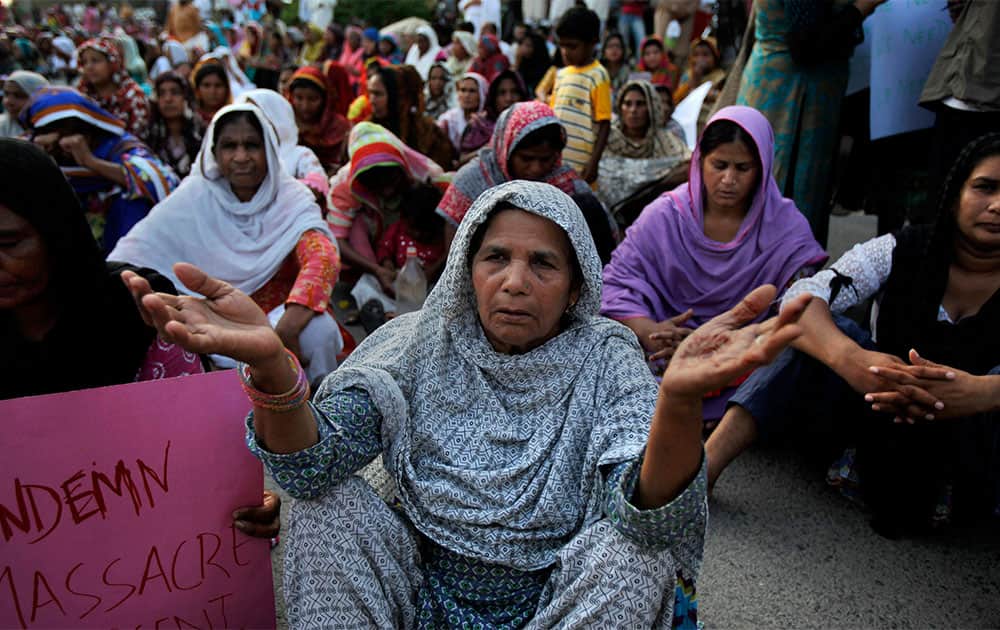 Pakistani Christian women pray for victims of suicide attack on a church in Peshawar, during a protest near the Parliament in Islamabad.