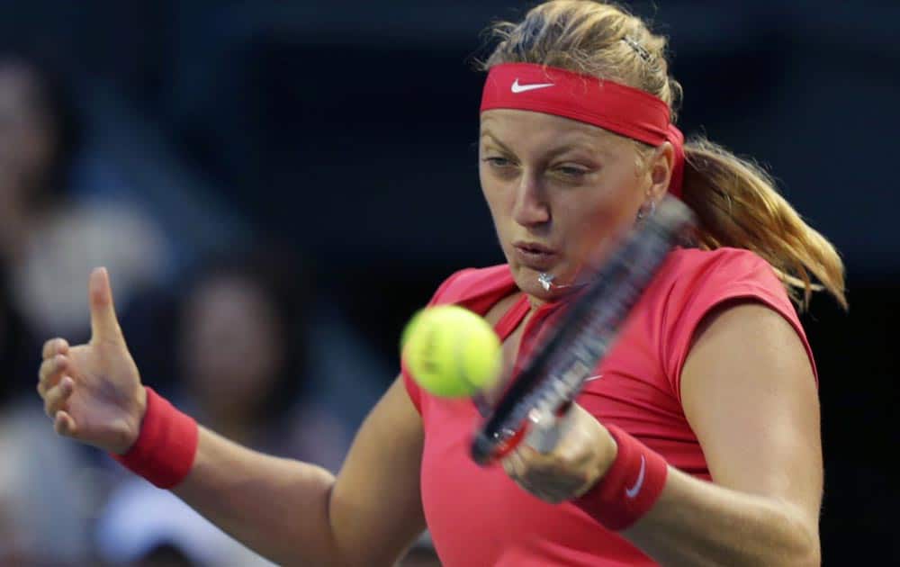 Petra Kvitova of the Czech Republic, returns the ball against Belinda Bencic of Switzerland during their first round match of Pan Pacific Open tennis tournament in Tokyo.