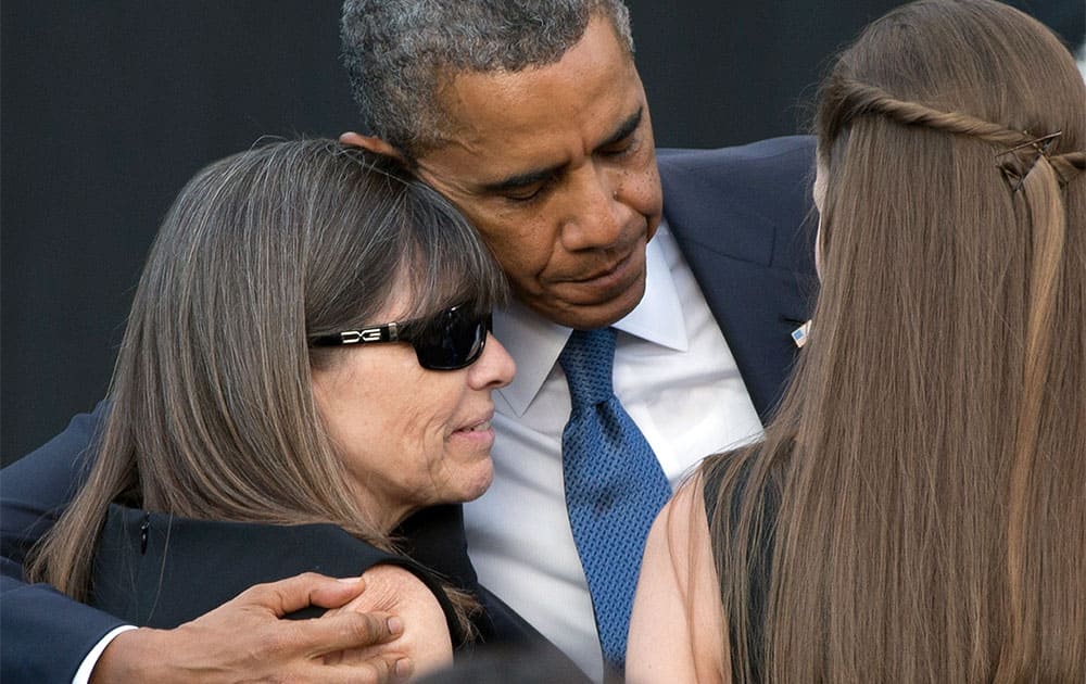 President Barack Obama hugs family members of victims during a memorial service for the victims of the Washington Navy Yard shooting at Marine Barracks Washington.